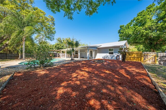 rear view of house featuring a fenced in pool, a patio, and a fenced backyard