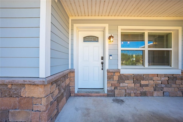 property entrance with stone siding