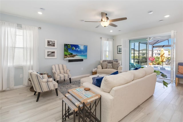 living room with recessed lighting, baseboards, ceiling fan, and light wood finished floors