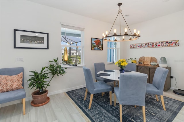 dining room with baseboards and wood finished floors