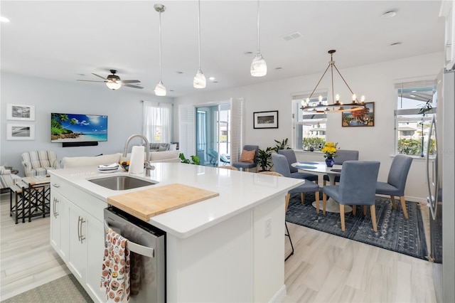 kitchen featuring visible vents, a healthy amount of sunlight, open floor plan, stainless steel appliances, and a sink