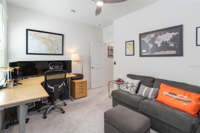 office space featuring visible vents, light carpet, and a ceiling fan