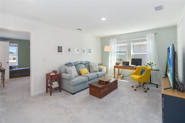 carpeted living room featuring visible vents and baseboards