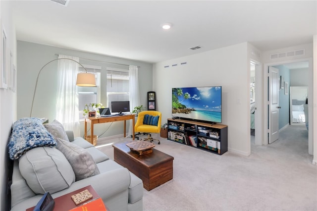 carpeted living room with visible vents and baseboards