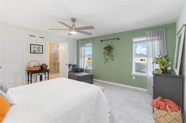 bedroom with light colored carpet, baseboards, and ceiling fan