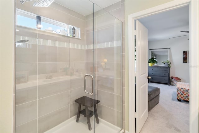 ensuite bathroom featuring a stall shower, ensuite bathroom, and a ceiling fan