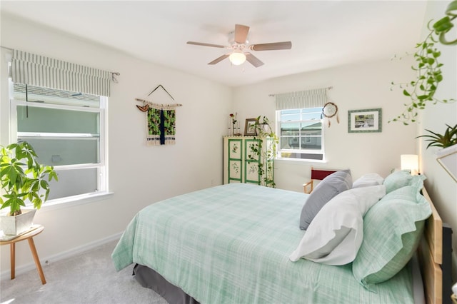 carpeted bedroom featuring a ceiling fan and baseboards