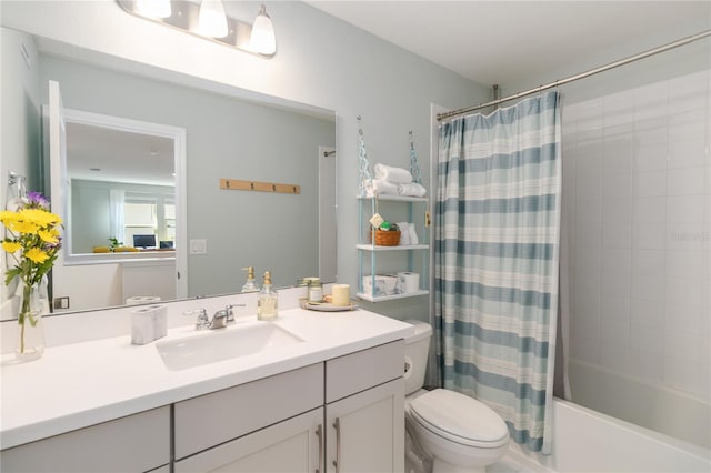 bathroom featuring vanity, shower / tub combo, and toilet