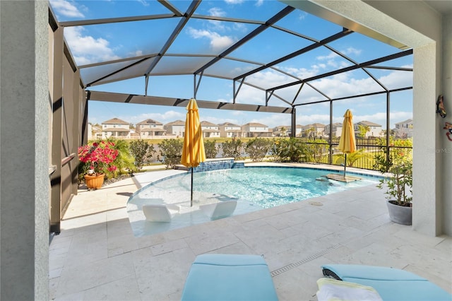 outdoor pool featuring a residential view, glass enclosure, and a patio