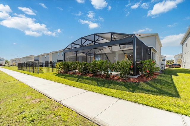 view of home's community with a yard, fence, and a residential view