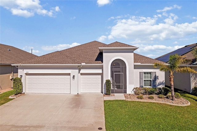 view of front of house featuring a front yard, roof with shingles, stucco siding, concrete driveway, and a garage