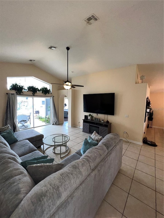 living room with lofted ceiling, light tile patterned floors, a ceiling fan, and visible vents