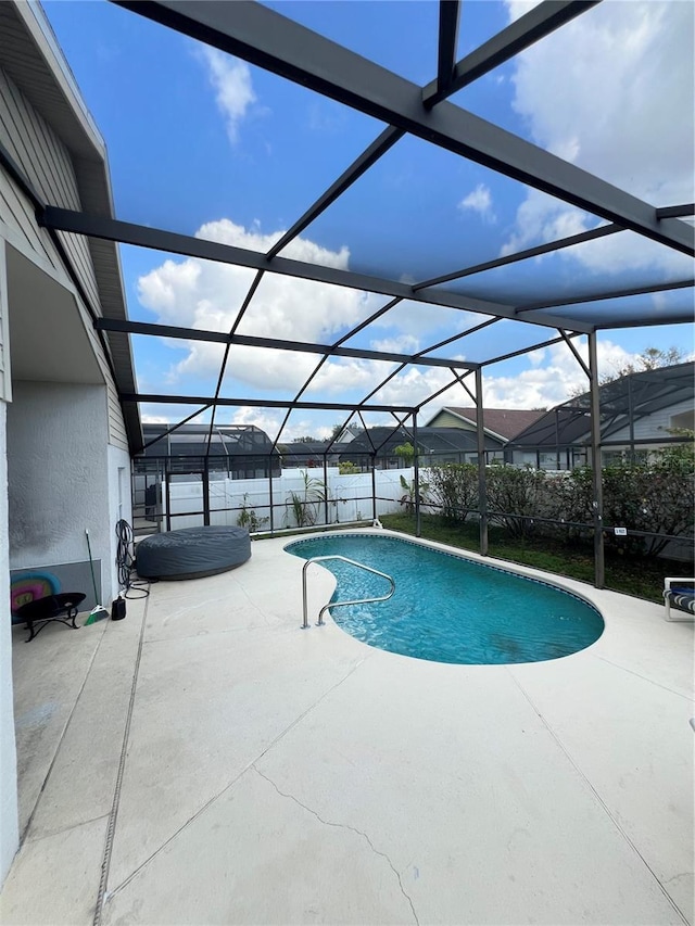 view of swimming pool featuring a fenced in pool, a patio, a lanai, and a water view