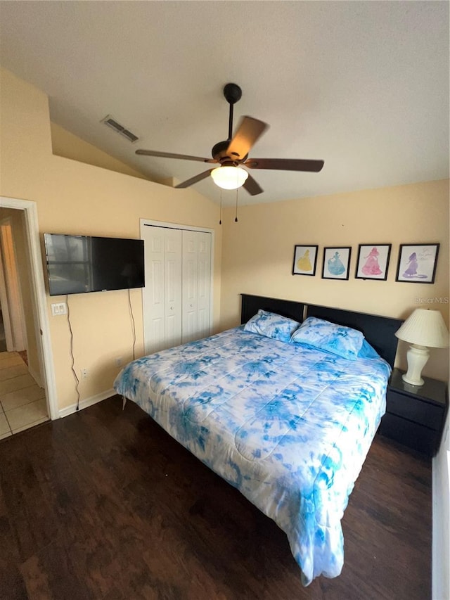 bedroom with visible vents, a ceiling fan, wood finished floors, a closet, and vaulted ceiling