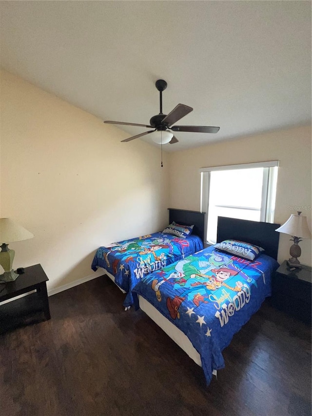 bedroom featuring baseboards and ceiling fan