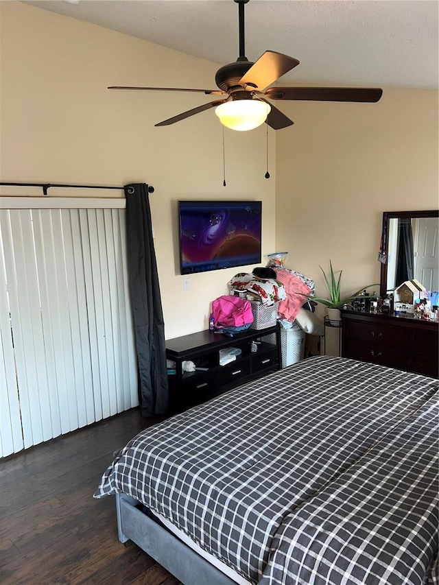 bedroom featuring ceiling fan, wood finished floors, and vaulted ceiling