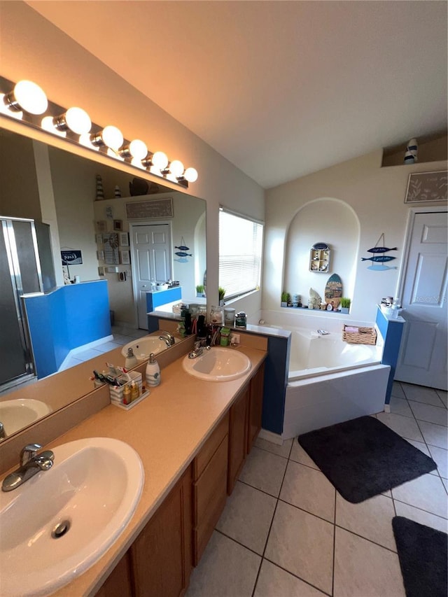 bathroom featuring tile patterned flooring, vaulted ceiling, and a sink