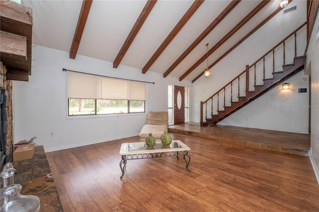 unfurnished living room with beam ceiling, high vaulted ceiling, wood finished floors, baseboards, and stairs