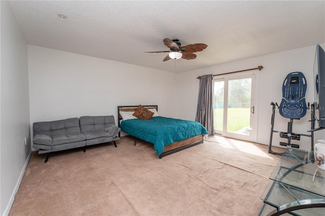 bedroom with baseboards, carpet flooring, a textured ceiling, a ceiling fan, and access to outside