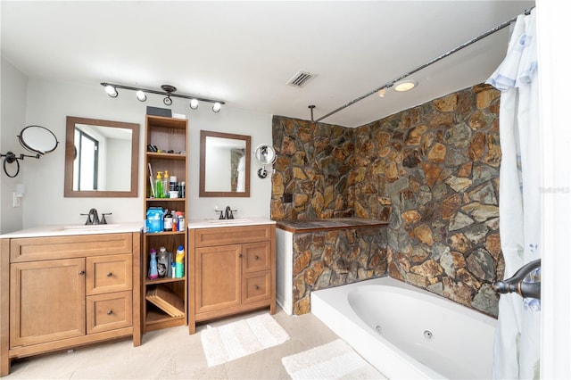 full bathroom with visible vents, vanity, a shower, and a whirlpool tub