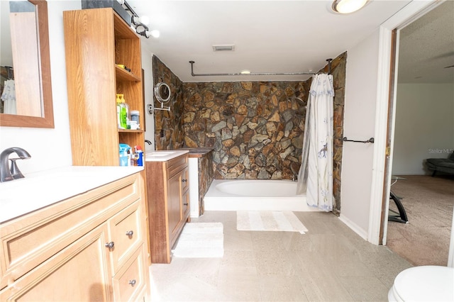 full bathroom with a shower with shower curtain, two vanities, visible vents, and a sink