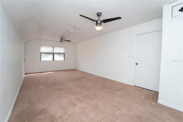 carpeted empty room with a textured ceiling and a ceiling fan