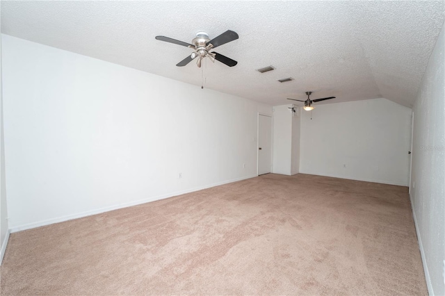 unfurnished room featuring visible vents, light carpet, a textured ceiling, and ceiling fan