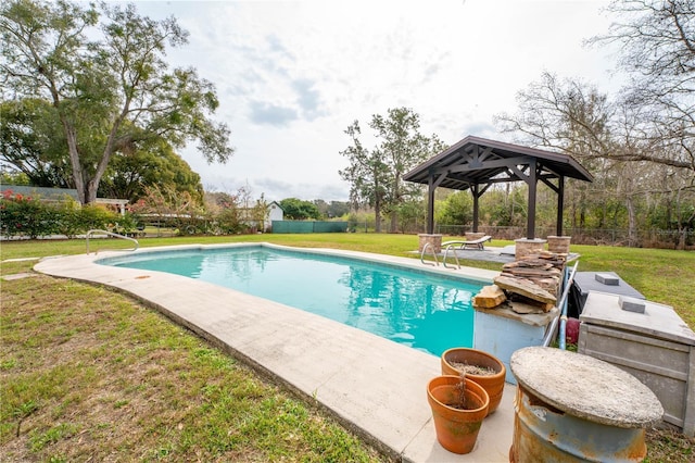 pool featuring a gazebo, a yard, and fence