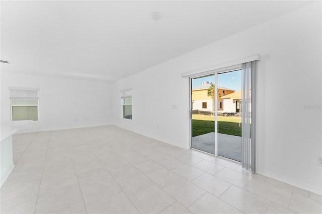 empty room featuring visible vents and light tile patterned flooring