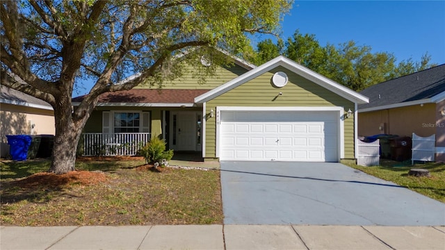 ranch-style house with covered porch, an attached garage, and driveway