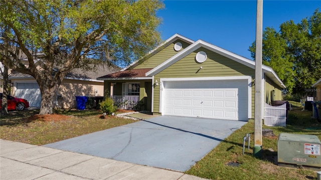 view of front of home featuring covered porch, concrete driveway, and an attached garage