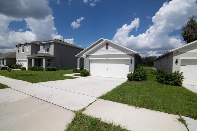 view of front of home featuring an attached garage, concrete driveway, and a front yard