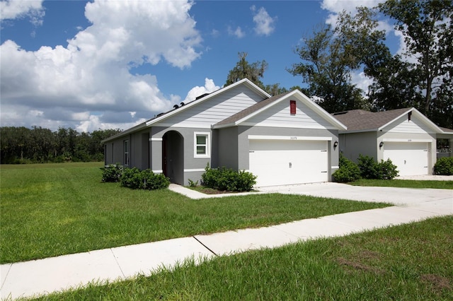 ranch-style home featuring stucco siding, driveway, roof with shingles, an attached garage, and a front yard