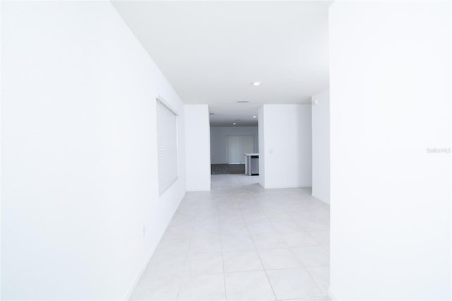 hall featuring recessed lighting and baseboards