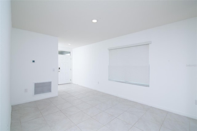 spare room with recessed lighting, baseboards, and visible vents