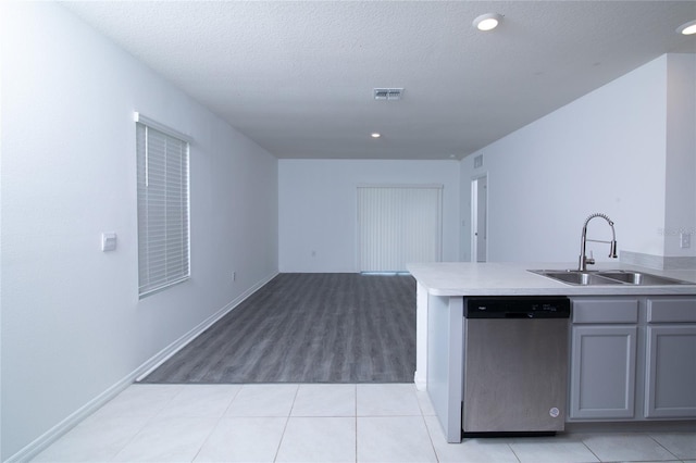 kitchen with visible vents, gray cabinets, a sink, dishwasher, and open floor plan