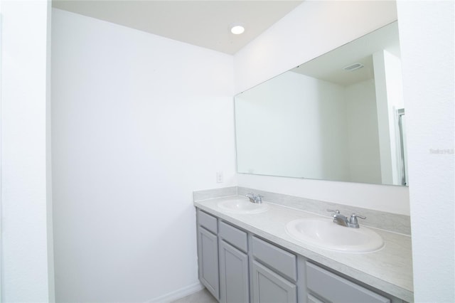 full bathroom featuring double vanity, visible vents, and a sink