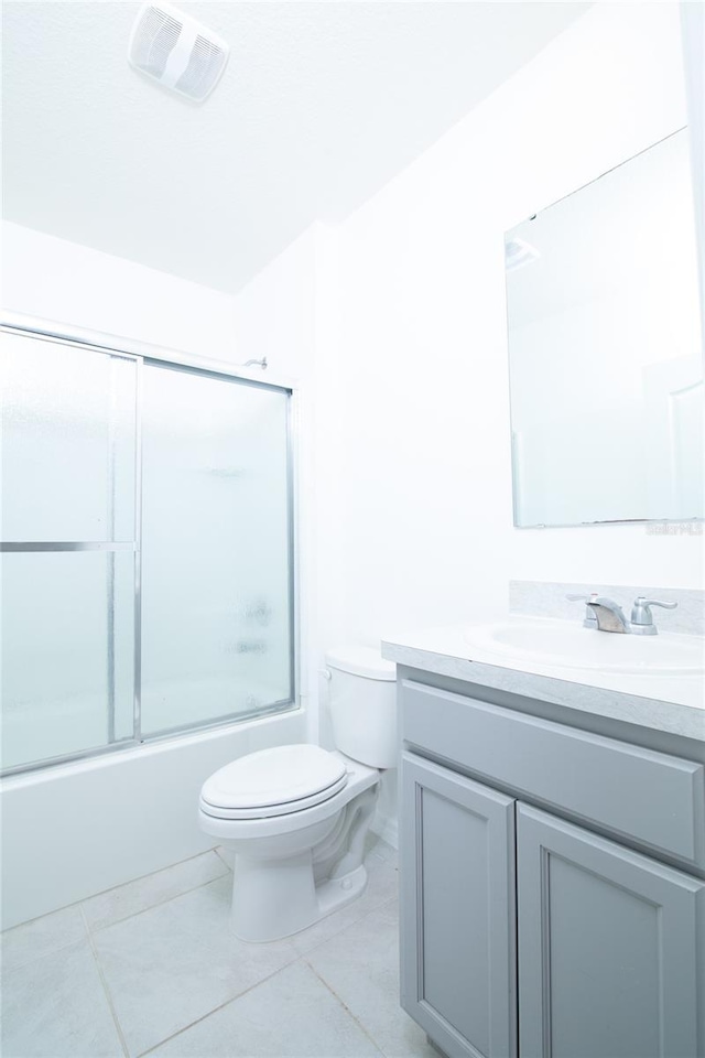 full bathroom with vanity, visible vents, tile patterned floors, toilet, and combined bath / shower with glass door