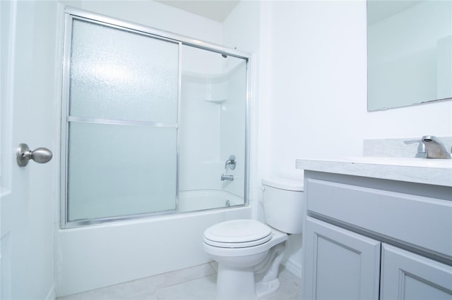 full bath with tile patterned flooring, toilet, vanity, and bath / shower combo with glass door