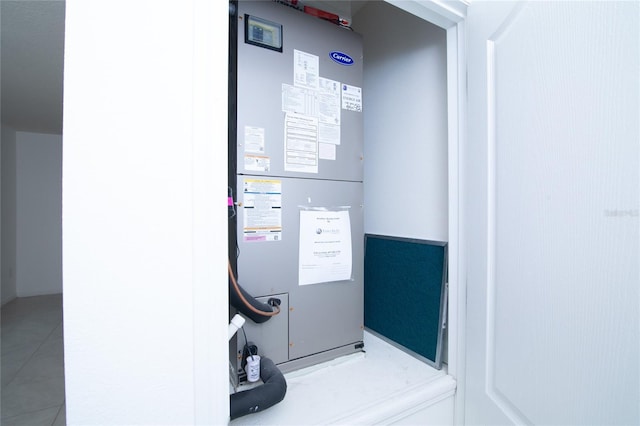 utility room featuring heating unit