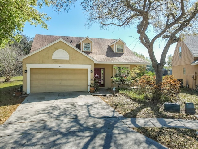 view of front of home with stucco siding, an attached garage, concrete driveway, and roof with shingles