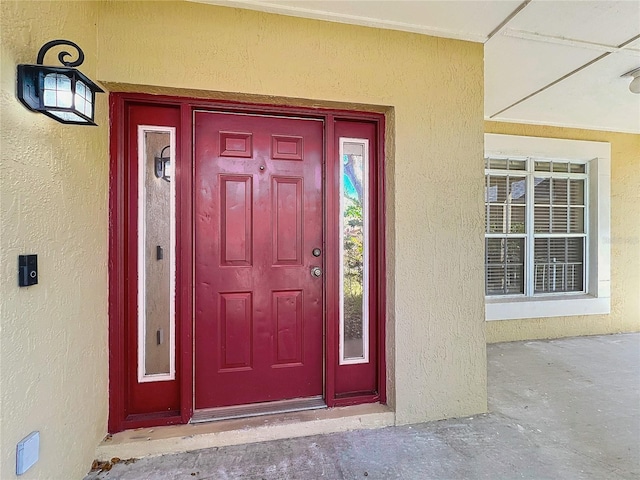 property entrance with stucco siding