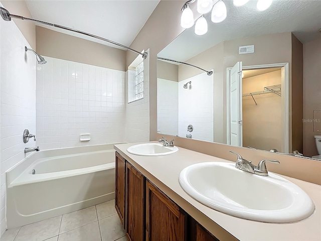 full bathroom featuring tile patterned flooring, visible vents,  shower combination, and a sink