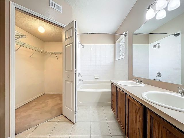 bathroom with a sink, visible vents, a textured ceiling, and shower / bathing tub combination