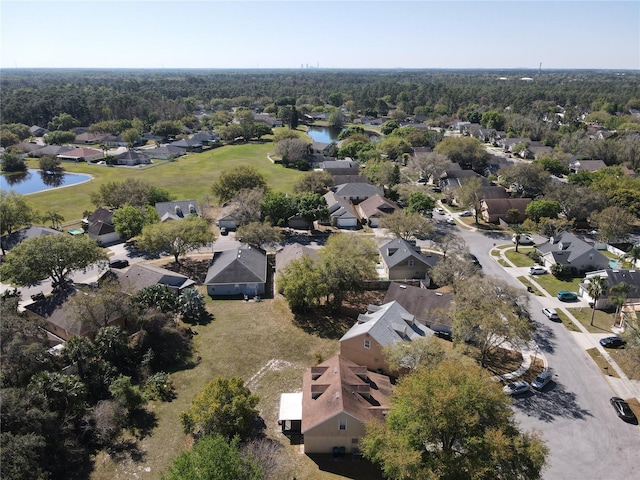 drone / aerial view featuring a residential view and a water view