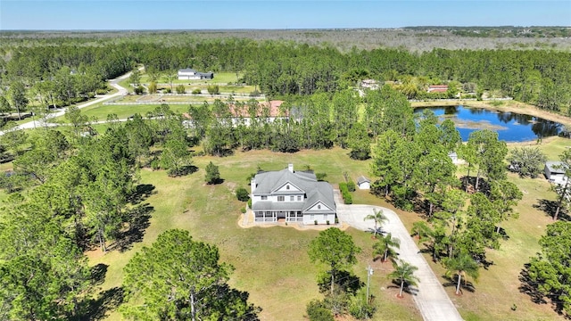 bird's eye view featuring a view of trees and a water view