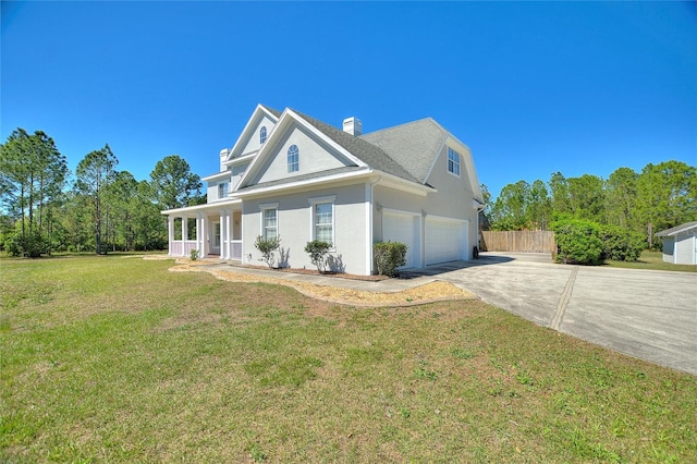 view of front facade featuring driveway, a chimney, stucco siding, a front lawn, and a garage