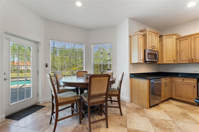 dining space featuring recessed lighting, baseboards, and light tile patterned flooring