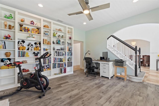 office area featuring visible vents, recessed lighting, light wood-style floors, arched walkways, and a ceiling fan