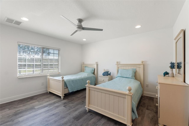 bedroom with visible vents, baseboards, and wood finished floors